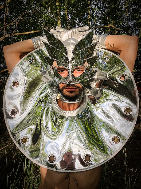 Sukha Forest - A man with with a silver mask with a silver shiny shoulder pads